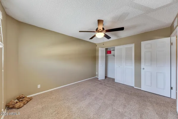 a view of a room with a ceiling fan