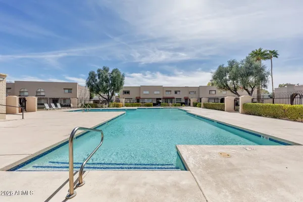 a swimming pool with outdoor seating and yard