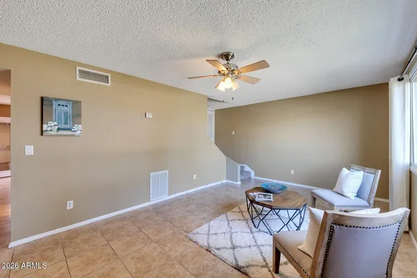 a view of a livingroom with chairs and a couch