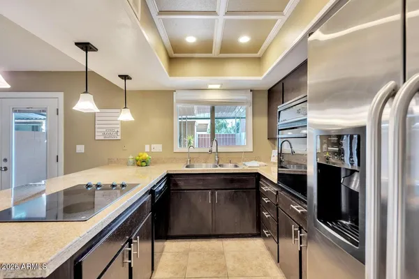 a large kitchen with a sink and stainless steel appliances