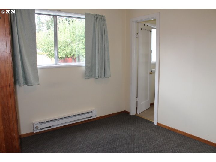 848 N Street Springfield, OR 97477 - Photo 17 of 33 a view of an empty room with wooden floor and a window