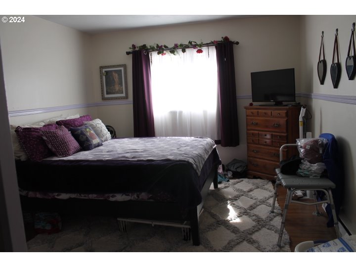 848 N Street Springfield, OR 97477 - Photo 27 of 33 a bedroom with a bed and flat tv screen on the dresser