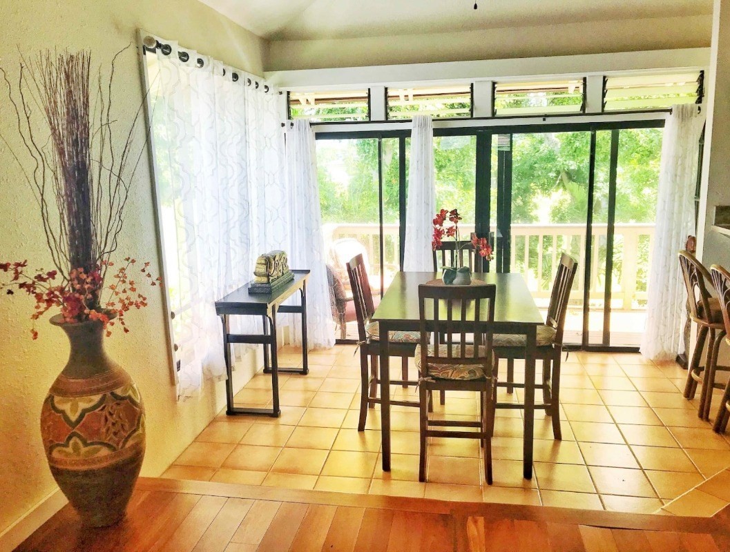 4480 Ka Haku Road, Unit 208 Princeville, HI 96722 - Photo 1 of 28 a view of a dining room with furniture wooden floor and a chandelier