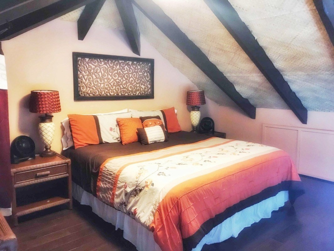 4480 Ka Haku Road, Unit 208 Princeville, HI 96722 - Photo 11 of 28 a bedroom with a bed and a painting on the wall