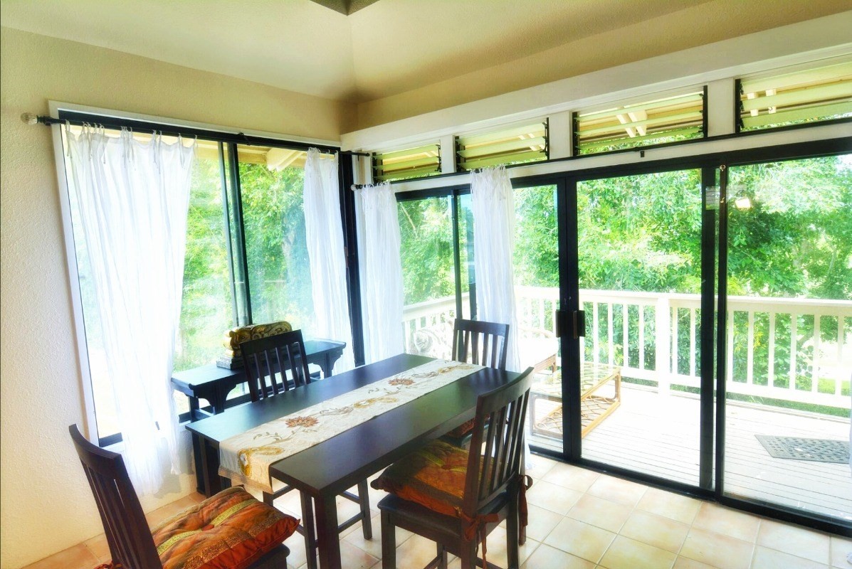 4480 Ka Haku Road, Unit 208 Princeville, HI 96722 - Photo 14 of 28 a view of a dining room with furniture large windows and wooden floor