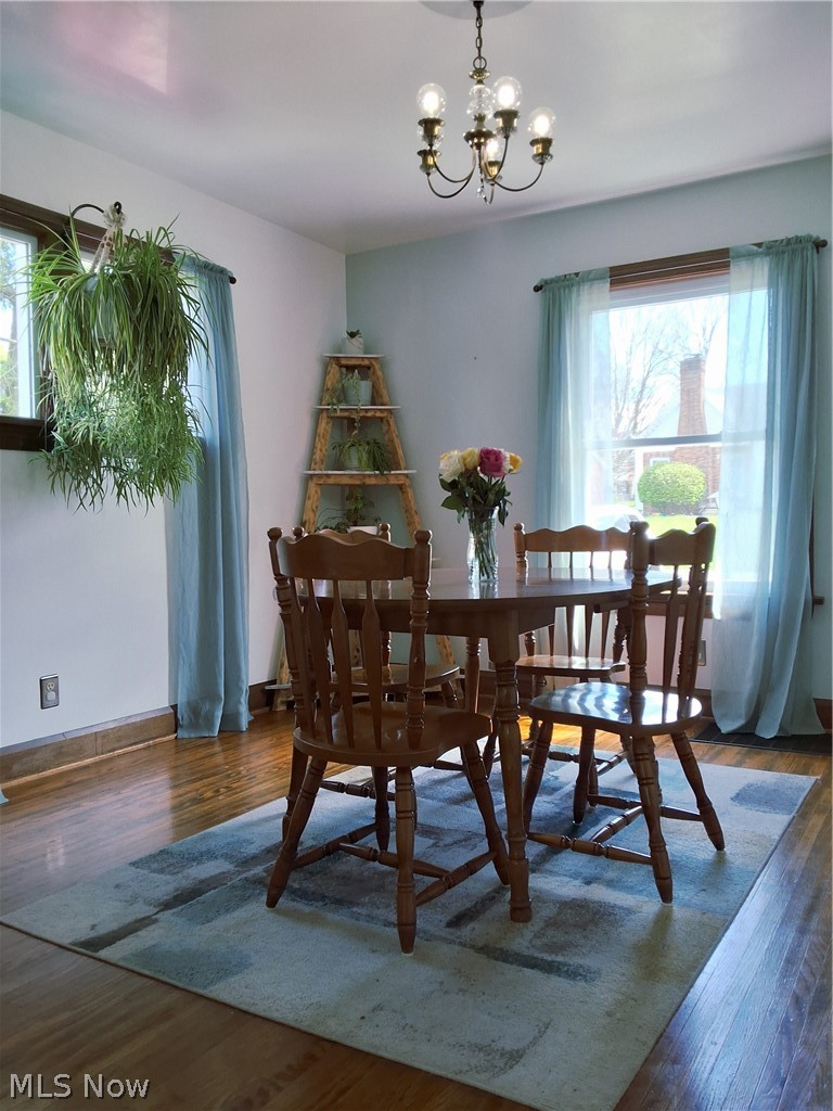 236 Bowland Road Mansfield, OH 44907 - Photo 11 of 34 Dining area featuring warm wood-finish flooring, light-colored walls, and a multi-light chandelier