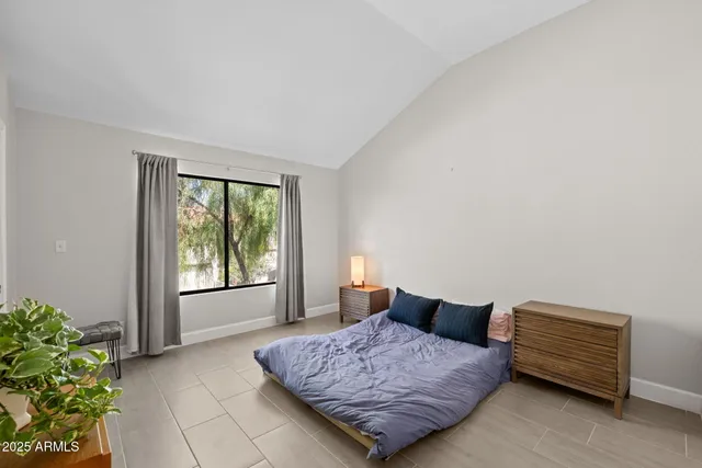 a bedroom with a bed plant and a window