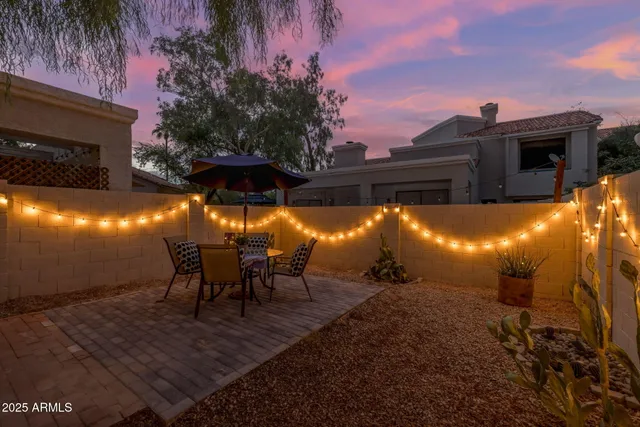 a view of a patio with table and chairs with a barbeque grill and plants