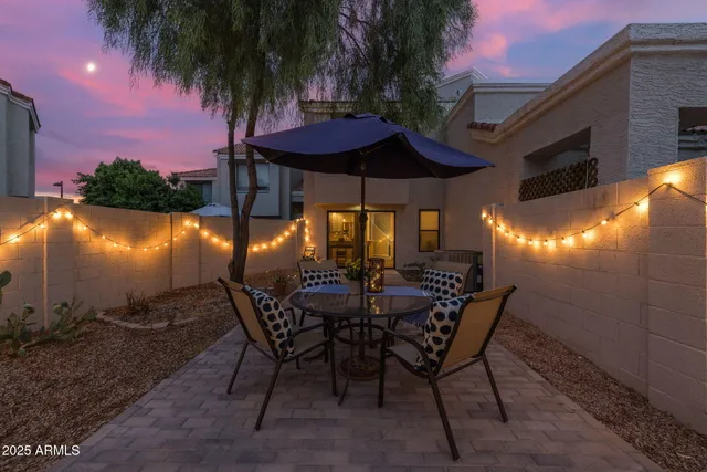 a view of a chairs and table in patio