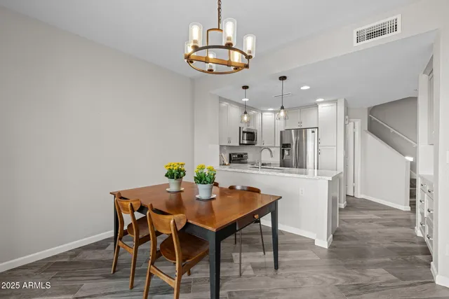 a view of a dining room with furniture and chandelier