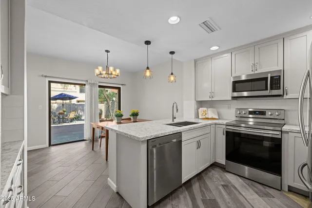 a kitchen with a stove sink and microwave