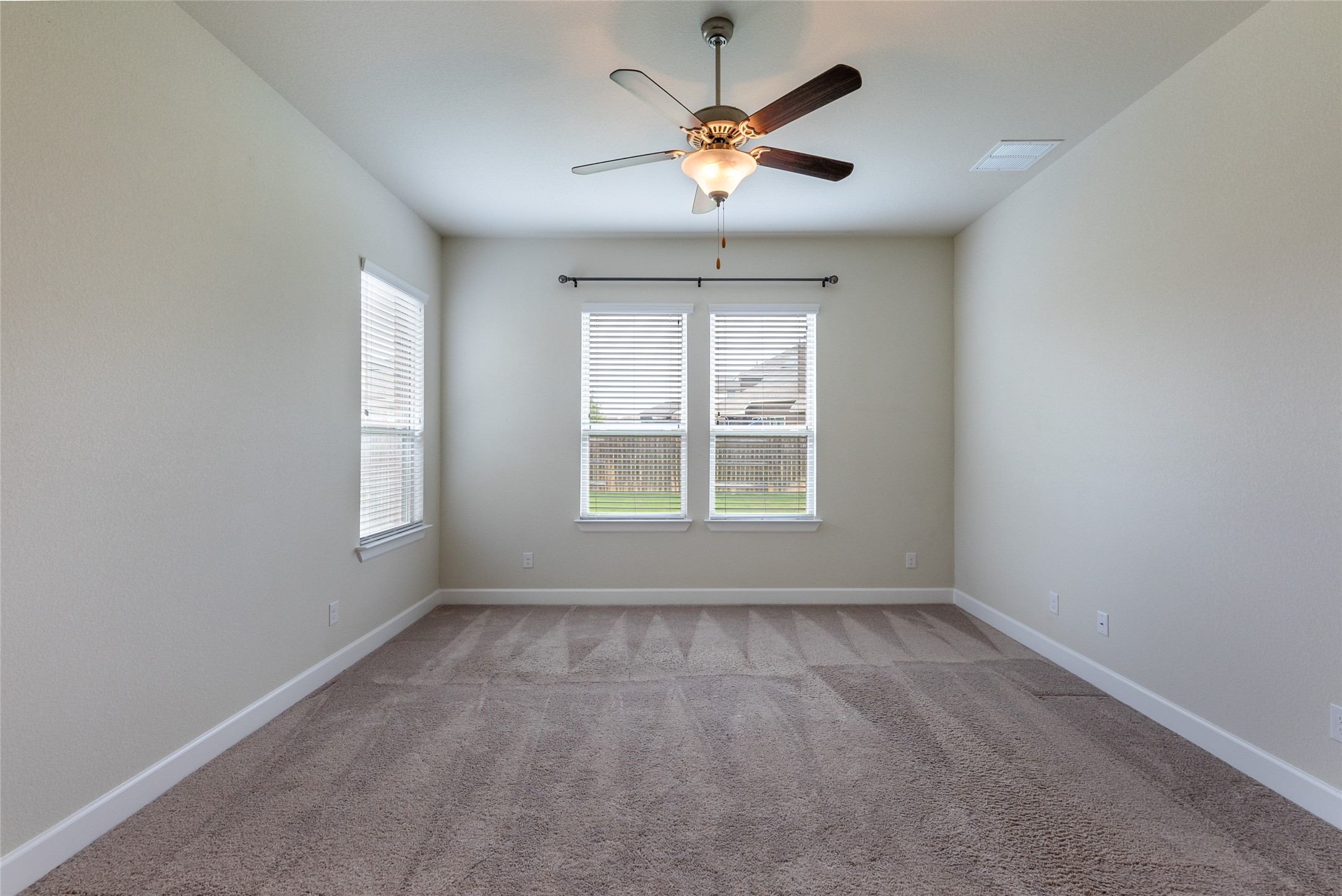 3043 Hidalgo Loop Round Rock, TX 78665 - Photo 10 of 34 Empty room with light colored carpet and a ceiling fan