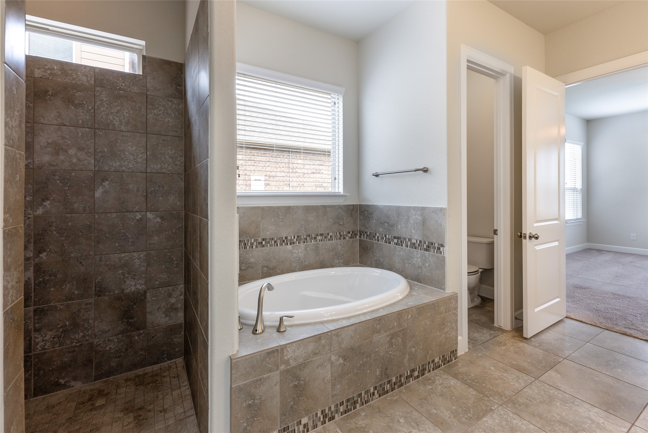 3043 Hidalgo Loop Round Rock, TX 78665 - Photo 13 of 34 Bathroom with a bath, a tile shower, and light tile patterned flooring