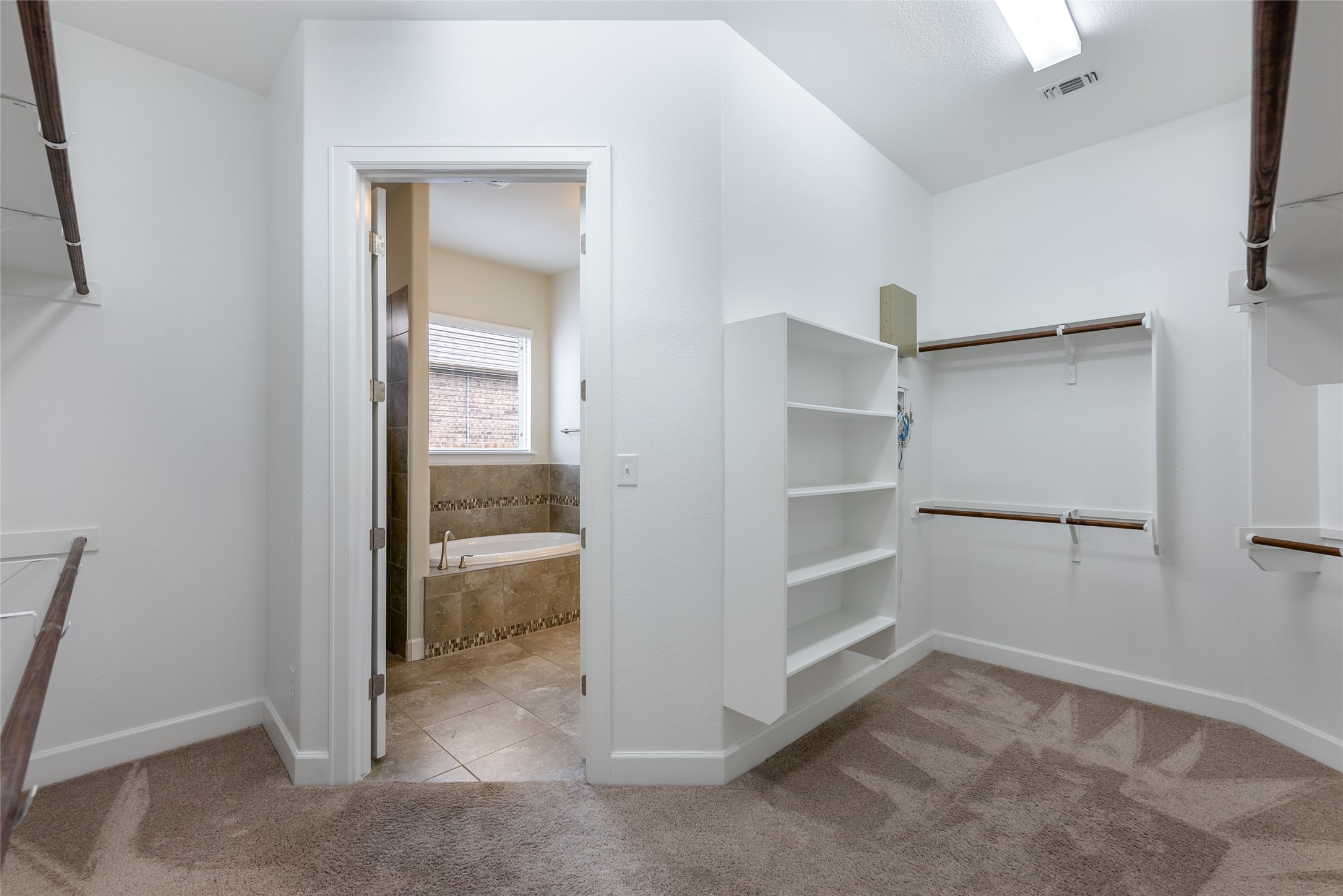 3043 Hidalgo Loop Round Rock, TX 78665 - Photo 15 of 34 Walk in closet with light carpet and light tile patterned floors