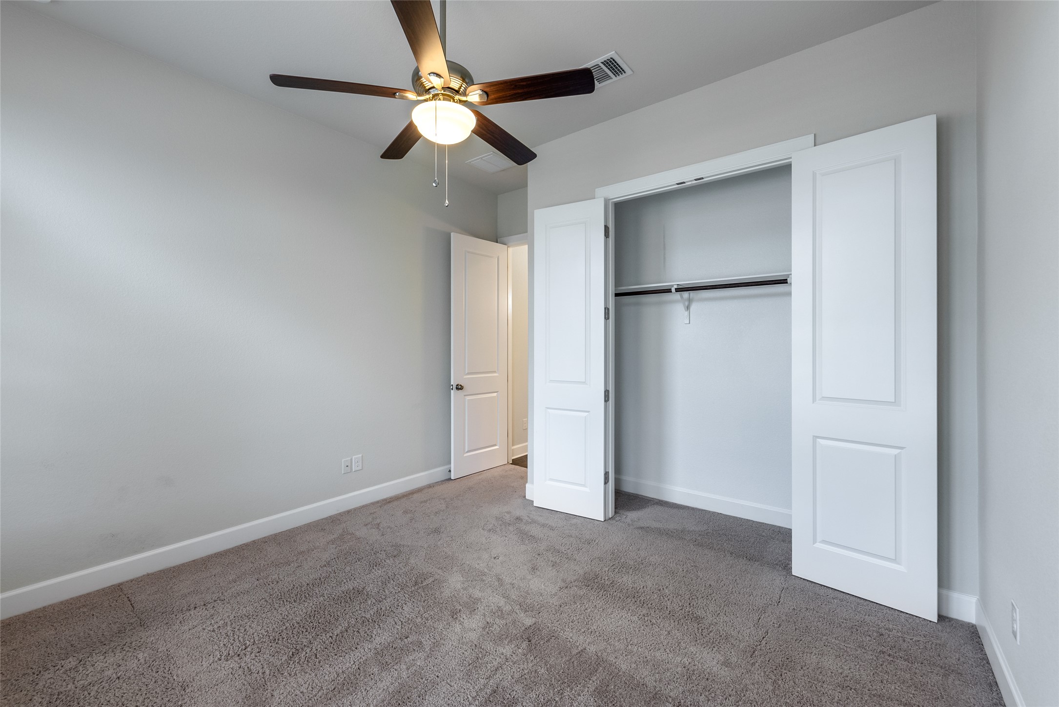 3043 Hidalgo Loop Round Rock, TX 78665 - Photo 17 of 34 Unfurnished bedroom featuring carpet, ceiling fan, and a closet