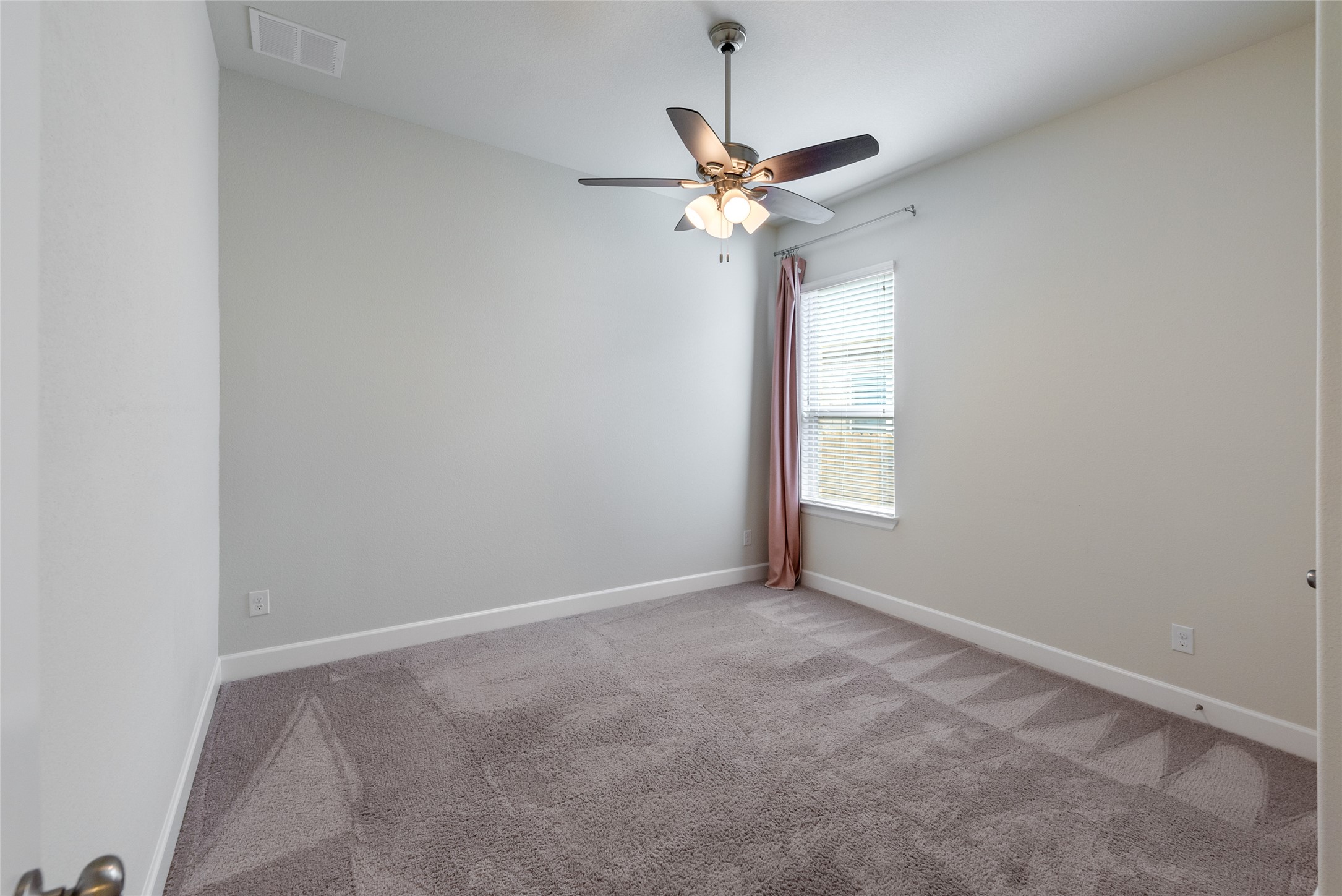 3043 Hidalgo Loop Round Rock, TX 78665 - Photo 18 of 34 Spare room featuring light carpet and ceiling fan
