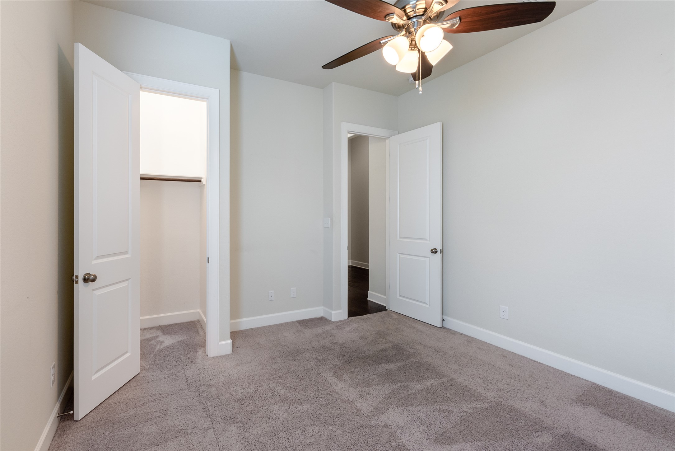 3043 Hidalgo Loop Round Rock, TX 78665 - Photo 19 of 34 Unfurnished bedroom with light carpet, ceiling fan, and a spacious closet