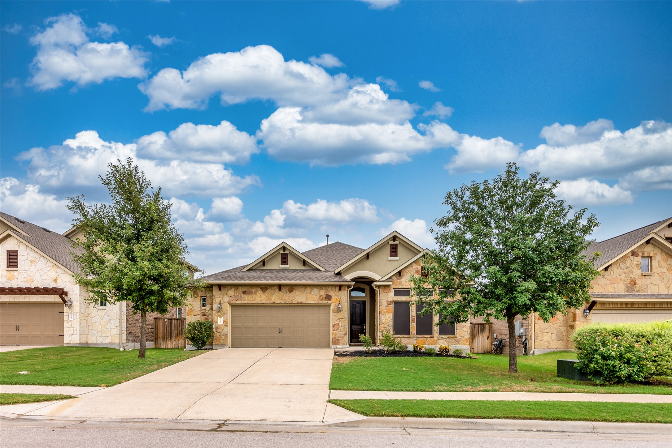 3043 Hidalgo Loop Round Rock, TX 78665 - Photo 2 of 34 Craftsman-style house featuring stone siding, a garage, and concrete driveway