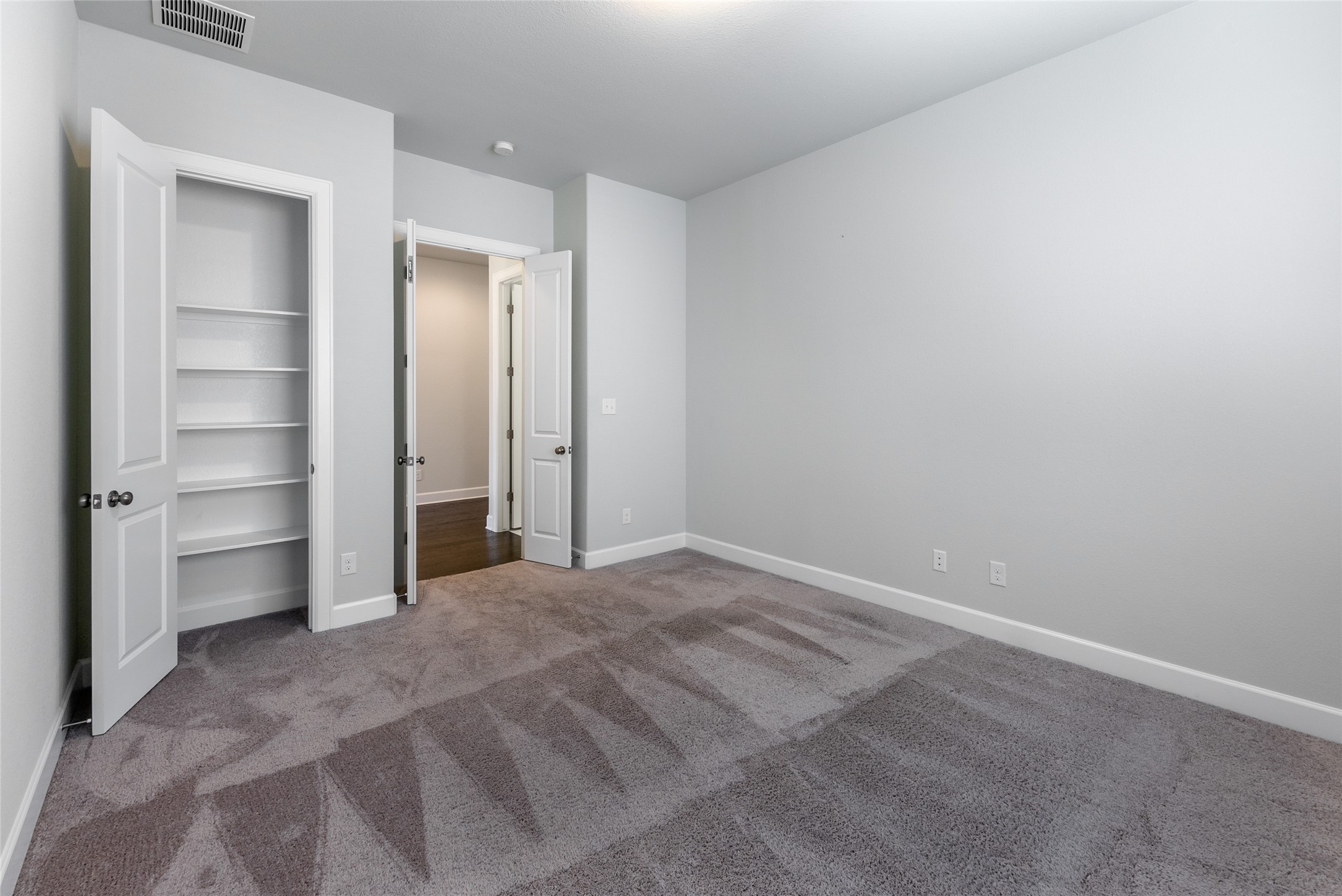 3043 Hidalgo Loop Round Rock, TX 78665 - Photo 22 of 34 Unfurnished bedroom featuring dark colored carpet and baseboards