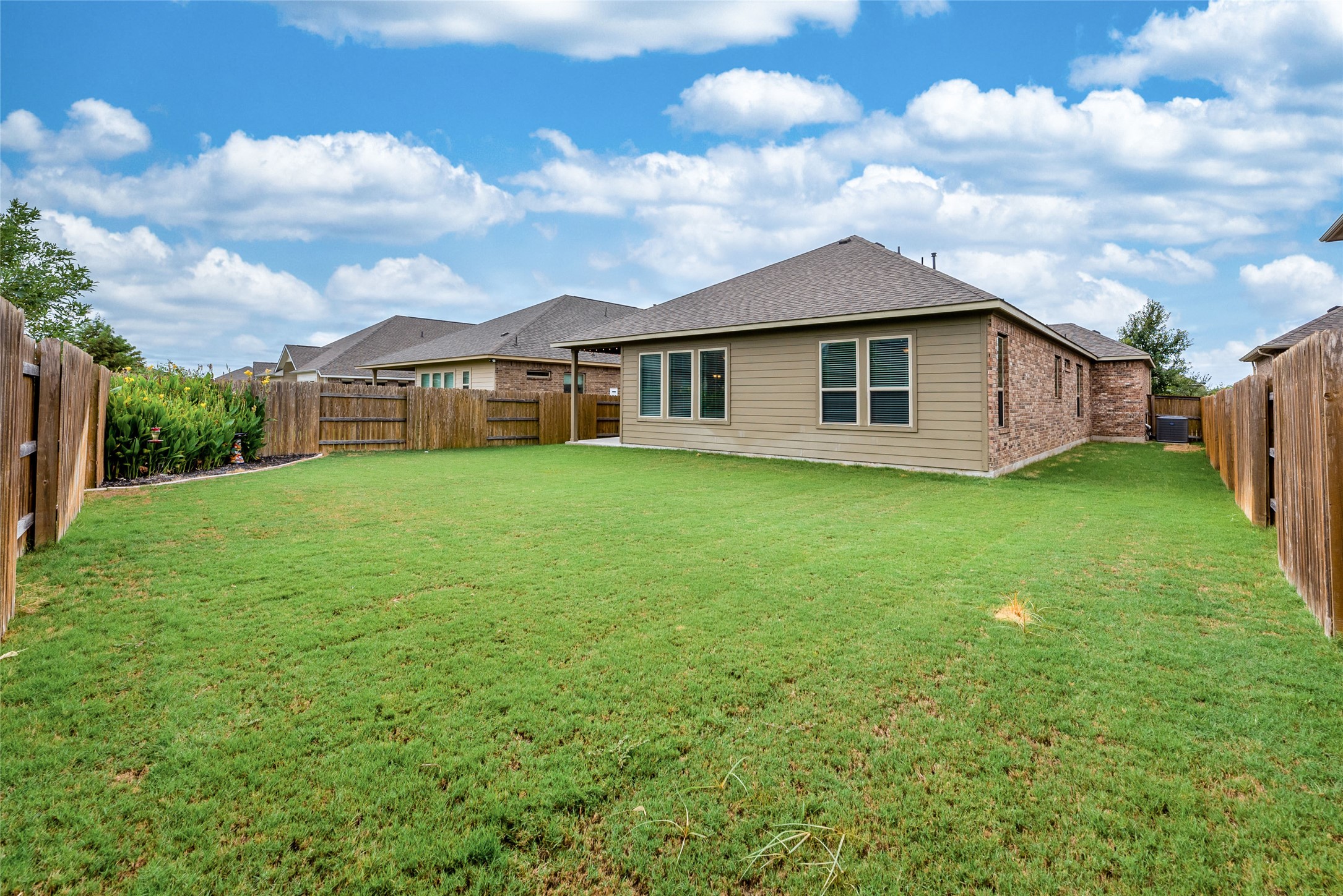 3043 Hidalgo Loop Round Rock, TX 78665 - Photo 27 of 34 Rear view of house featuring a fenced backyard and roof with shingles