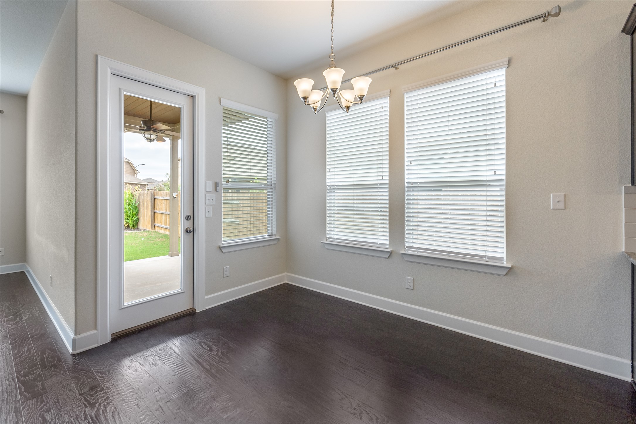 3043 Hidalgo Loop Round Rock, TX 78665 - Photo 8 of 34 Unfurnished dining area with dark wood finished floors, suspended lighting, and ceiling fan