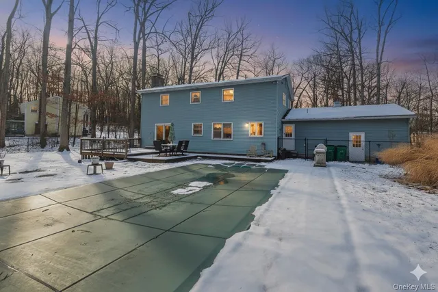 a view of a patio with table and chairs under an umbrella