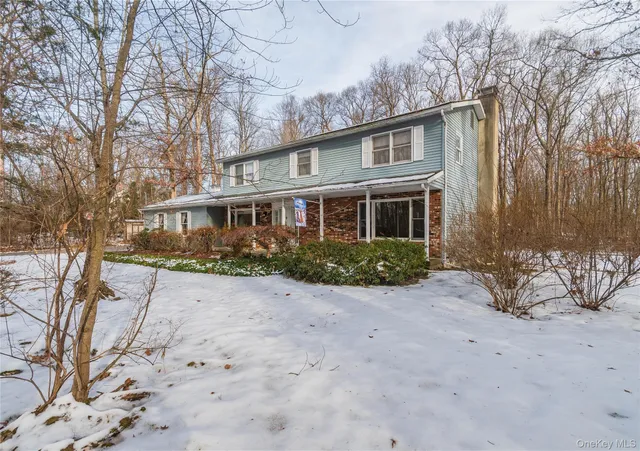 a view of a house with a yard covered in snow