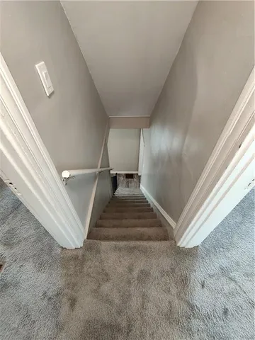 a bedroom with a bed window and couch