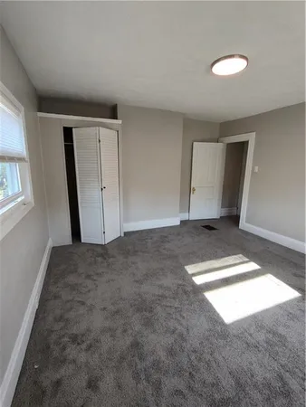 a bedroom with double bed and a window