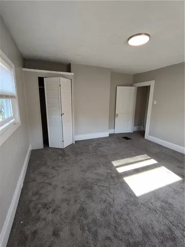 a bedroom with double bed and a window