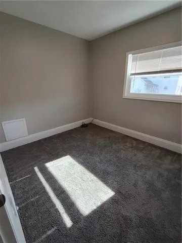 a bedroom with bed and a window