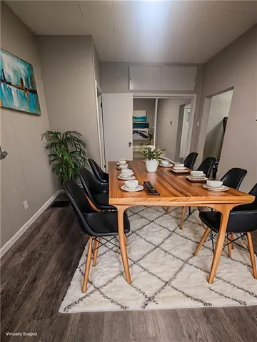 an empty room with wooden floor and mirror