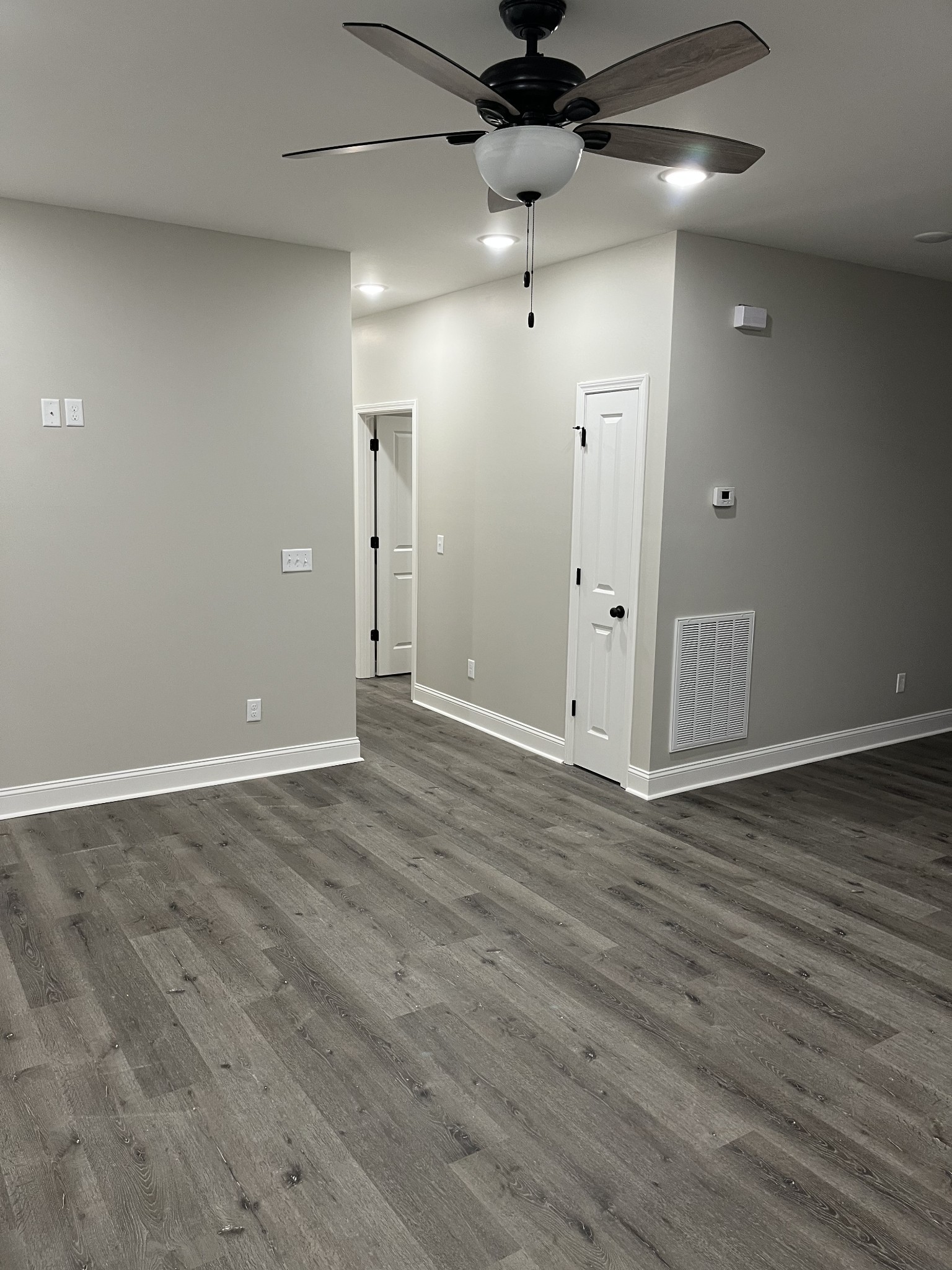 9970 West Green Cemetery Road Bon Aqua, TN 37025 - Photo 3 of 8 an empty room with wooden floor and windows
