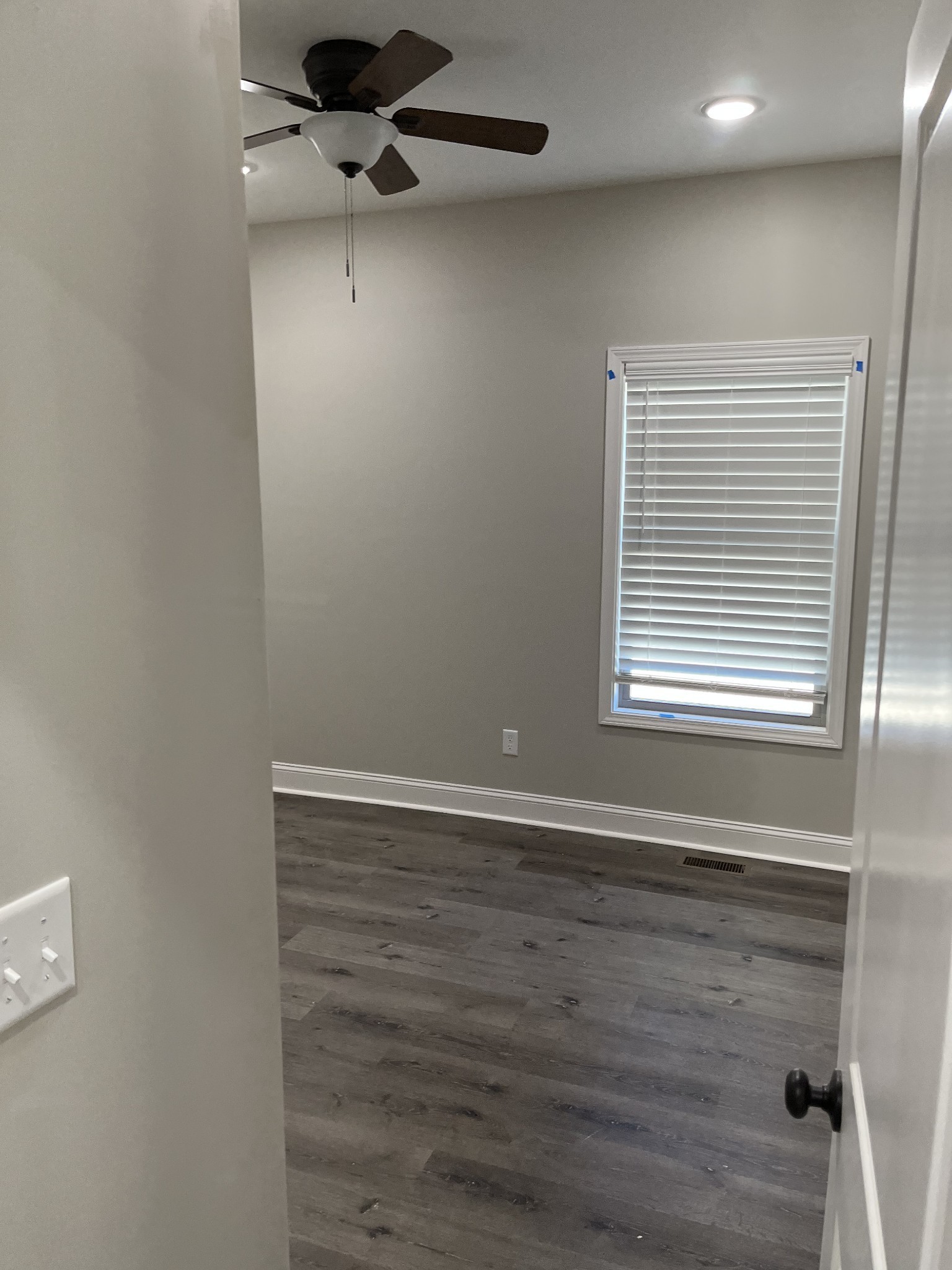 9970 West Green Cemetery Road Bon Aqua, TN 37025 - Photo 5 of 8 a view of an empty room with a window and wooden floor