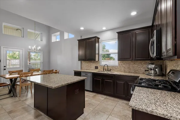 a kitchen with a stove a sink and a refrigerator