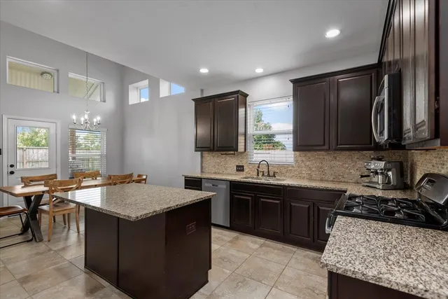 a kitchen with a stove a sink and a refrigerator