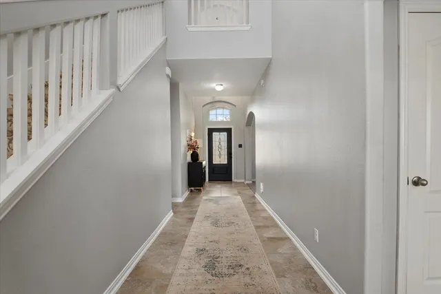 a view of a hallway with wooden floor and entryway