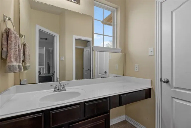 a bathroom with a sink and a mirror