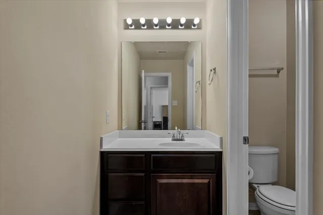 a bathroom with a sink and a mirror with toilet