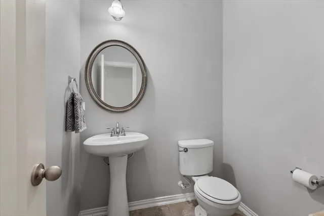 a bathroom with a sink toilet and a mirror