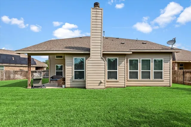 a front view of a house with a garden and yard