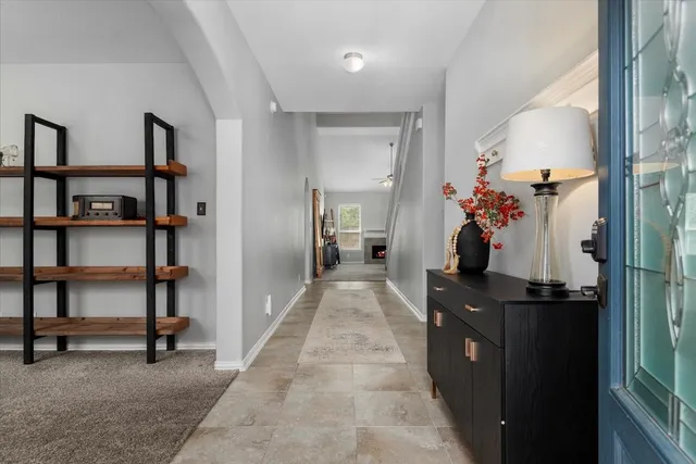 a view of a hallway to room and dining room