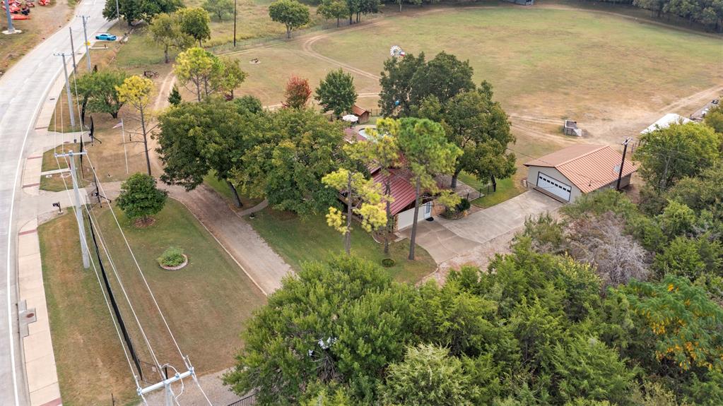 an aerial view of a house with a yard