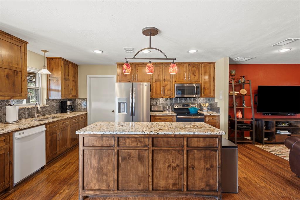 1009 West Interstate 20 Grand Prairie, TX 75052 - Photo 12 of 40 a dining hall with stainless steel appliances granite countertop a stove and a sink