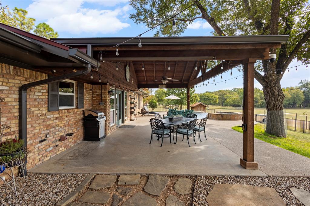 1009 West Interstate 20 Grand Prairie, TX 75052 - Photo 19 of 40 a view of a porch with dining table and chairs