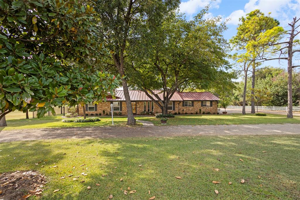 1009 West Interstate 20 Grand Prairie, TX 75052 - Photo 3 of 40 a view of a house with a big yard and large trees
