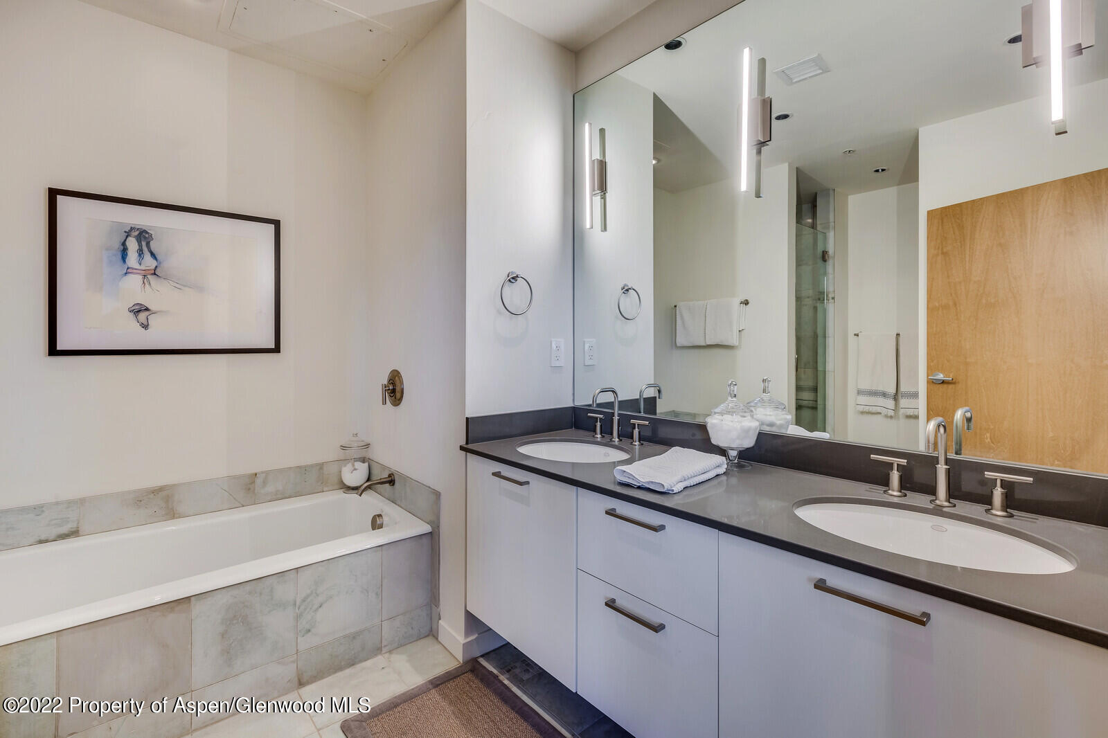 231 Robinson Street, Unit 312 Basalt, CO 81621 - Photo 12 of 25 a bathroom with a granite countertop tub sink and mirror