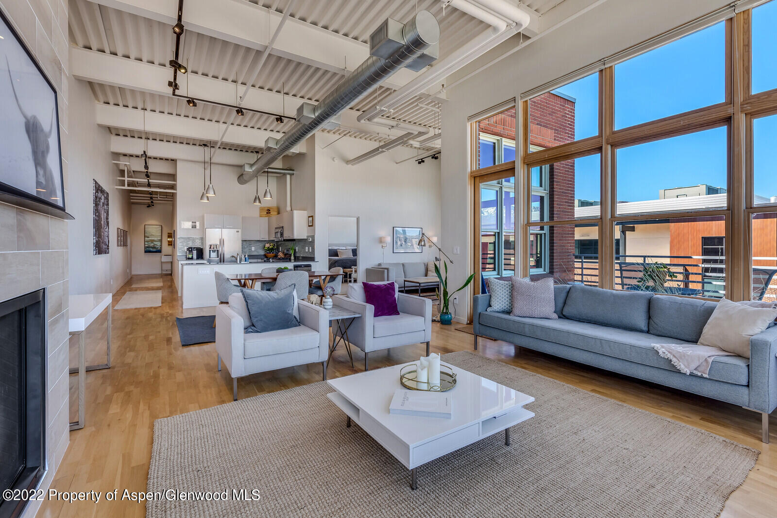 231 Robinson Street, Unit 312 Basalt, CO 81621 - Photo 2 of 25 a living room with furniture wooden floor and a table