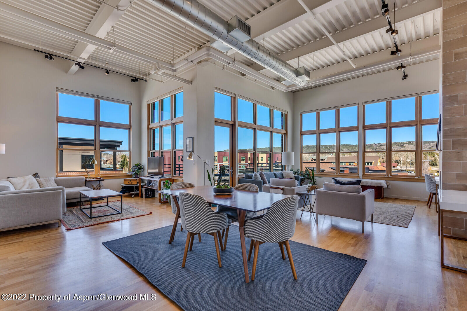231 Robinson Street, Unit 312 Basalt, CO 81621 - Photo 3 of 25 a dining room with wooden floor a table and chairs