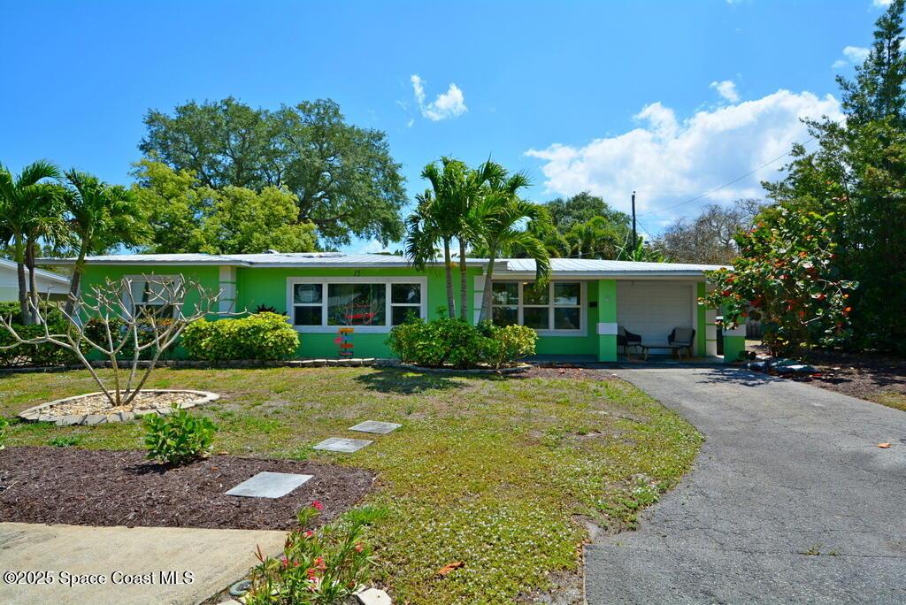 15 Hardee Circle South Rockledge, FL 32955 - Photo 1 of 44 a front view of a house with a garden